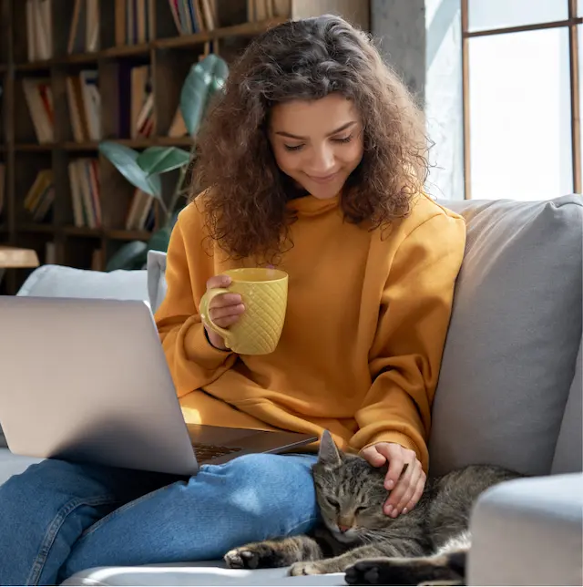 Une femme caressant son chat assuré chez Assur O’poil et satisfaite de son remboursement